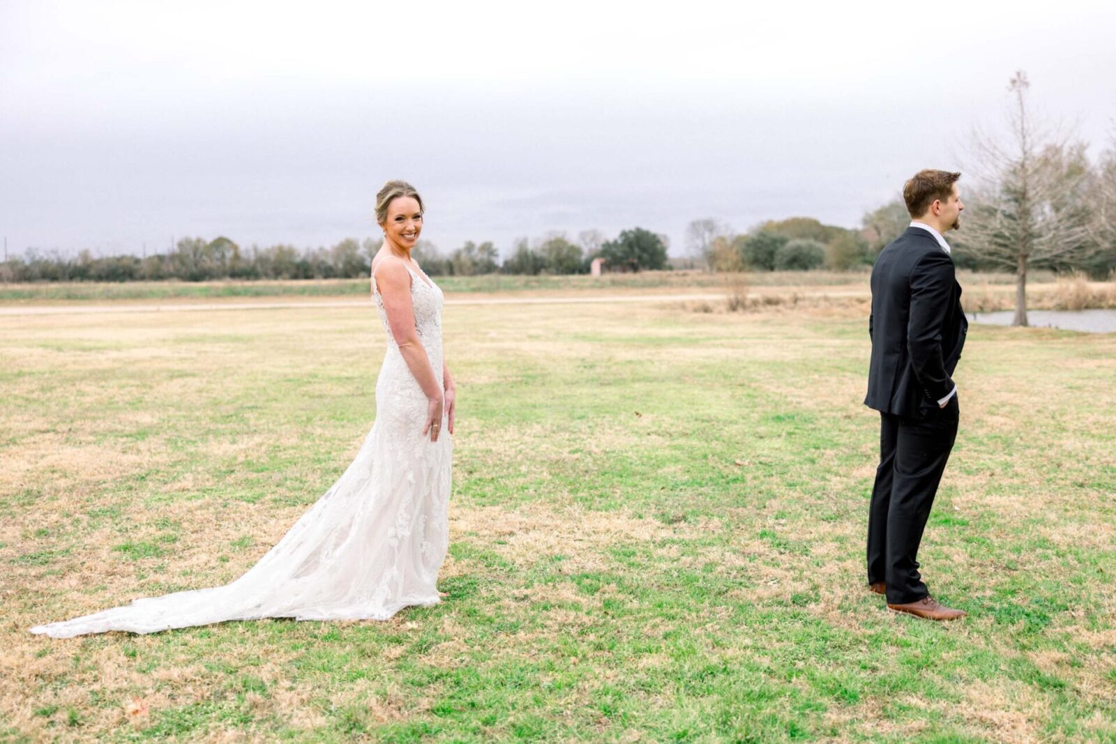 A bride behind her groom for a first look