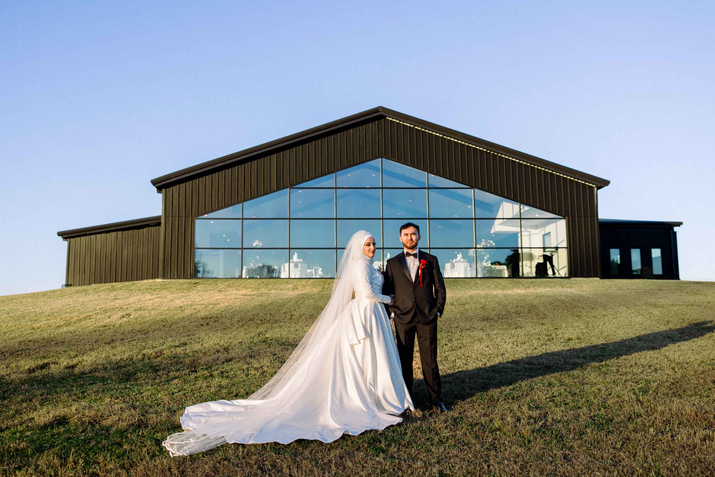 A bride and groom in front of a wedding venue